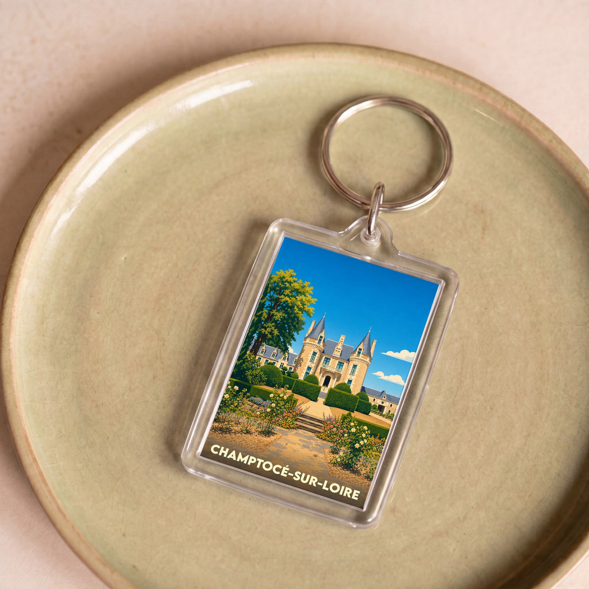 Porte-clés souvenir de la ville de Champtocé-sur-Loire avec une illustration stylisée de son château.