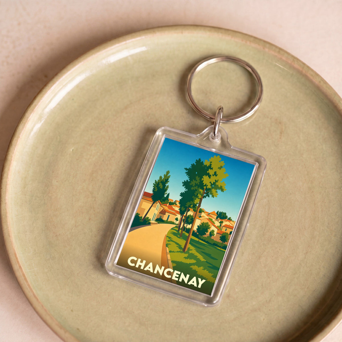 Porte-clés souvenir de la ville de Chancenay avec une illustration stylisée et colorée.
