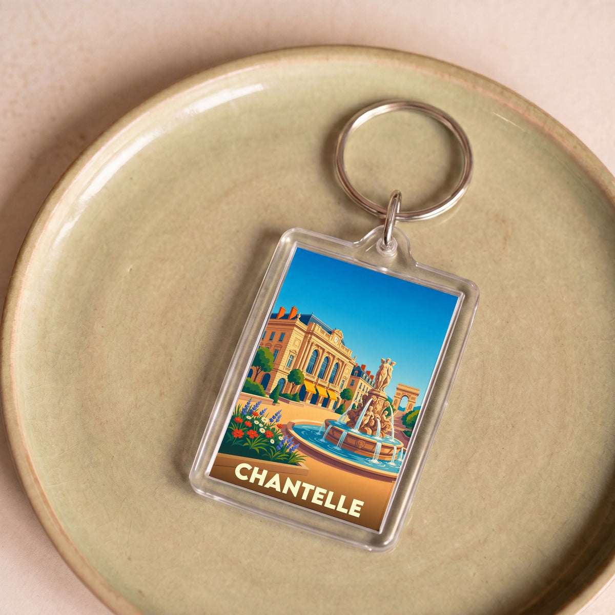 Porte-clés souvenir de la ville de Chantelle avec une illustration stylisée.