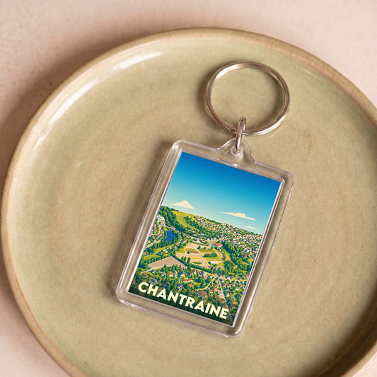Porte-clés souvenir de la ville de Chantraine avec une illustration stylisée et colorée.