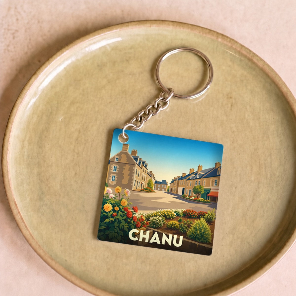 Porte-clés souvenir de la ville de Chanu avec une illustration stylisée.