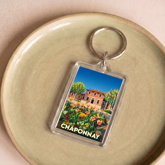 Porte-clés souvenir de la ville de Chaponnay avec une illustration stylisée et colorée.