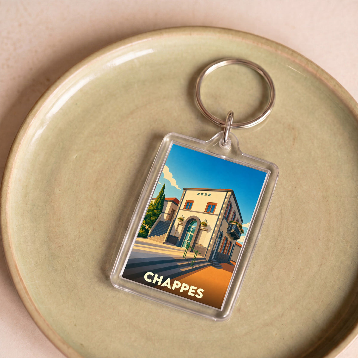 Porte-clés souvenir de la ville de Chappes avec une illustration stylisée.