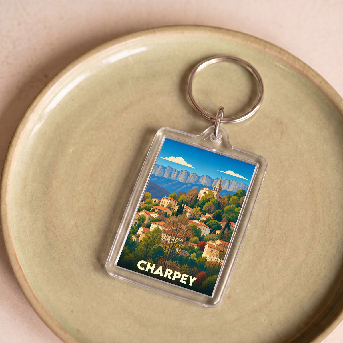 Porte-clés souvenir de la ville de Charpey avec une illustration stylisée.