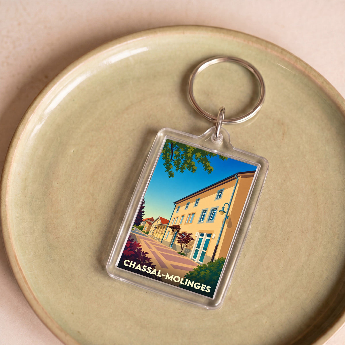 Porte-clés souvenir de la ville de Chassal-Molinges avec une illustration stylisée.