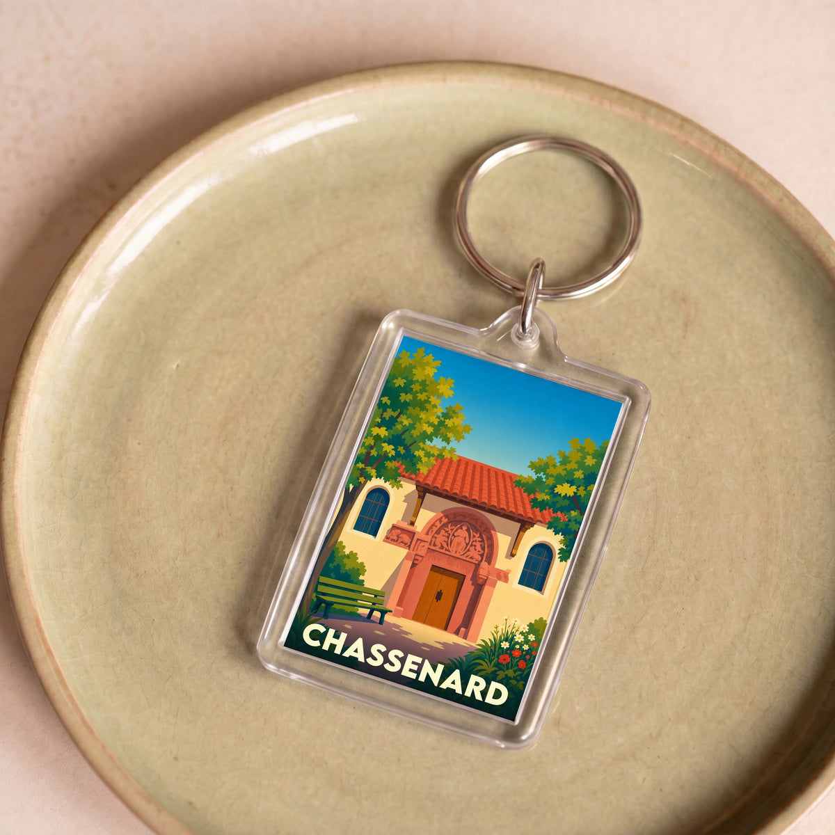 Porte-clés souvenir de la ville de Chassenard avec une illustration stylisée de son église.
