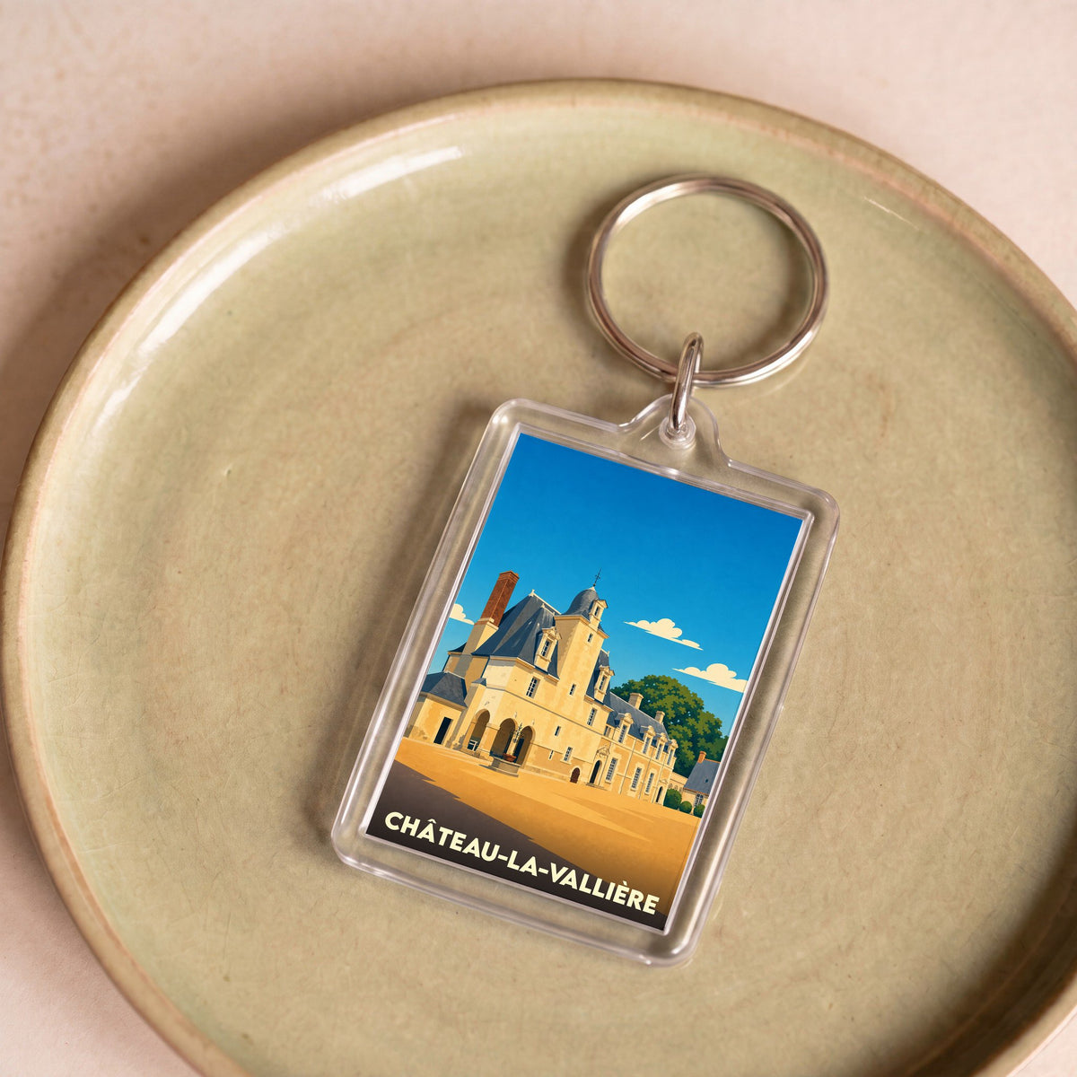 Porte-clés souvenir de la ville de Château-la-Vallière avec une illustration stylisée de son château.