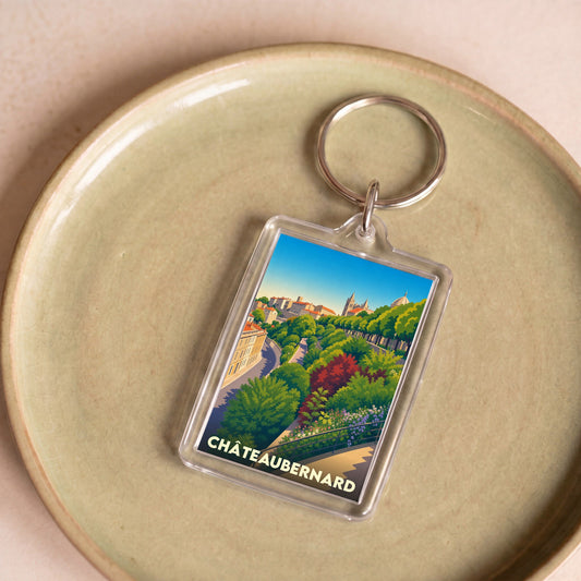 Porte-clés souvenir de la ville de Châteaubernard avec une illustration stylisée et colorée.