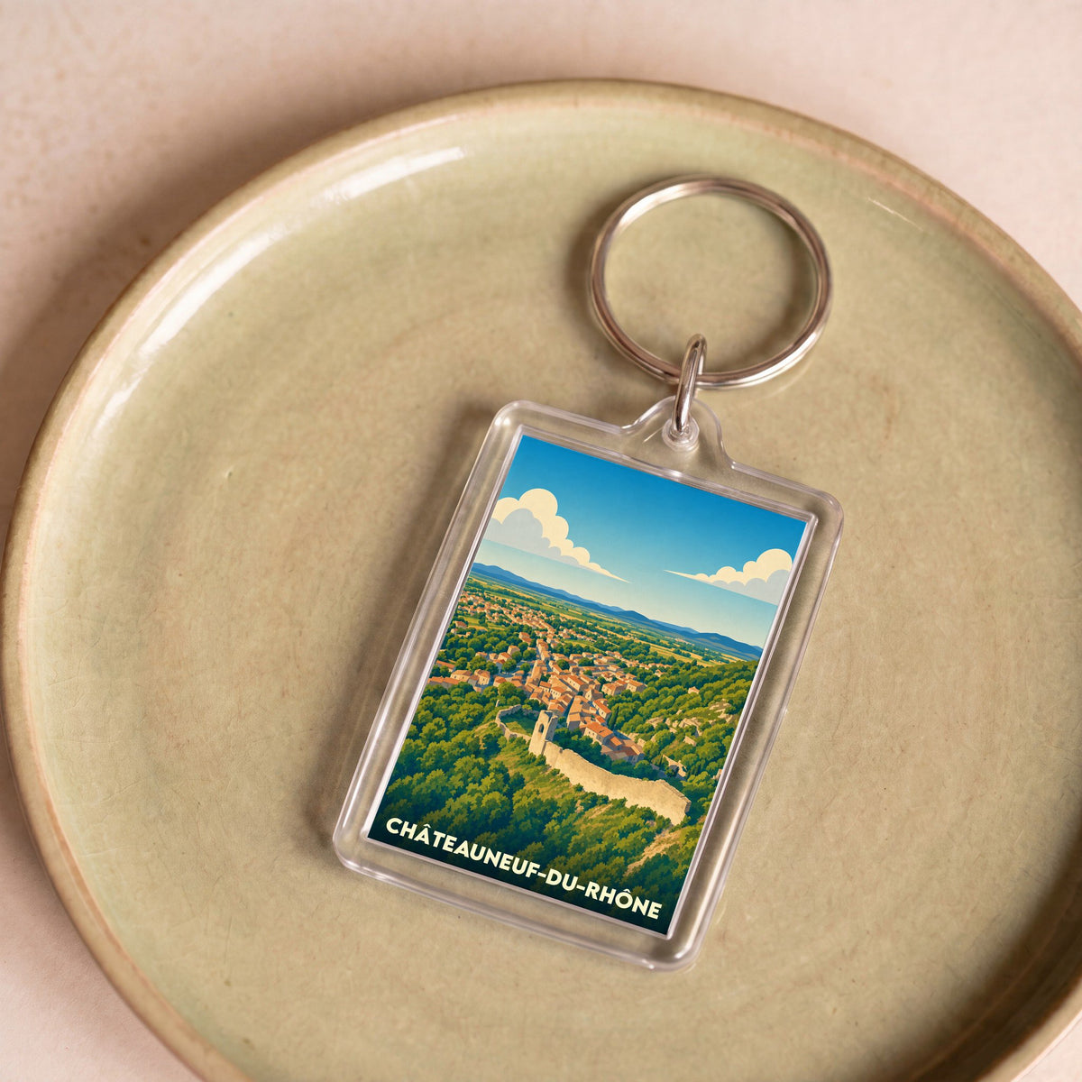 Porte-clés souvenir de la ville de Châteauneuf-du-Rhône avec une illustration stylisée.