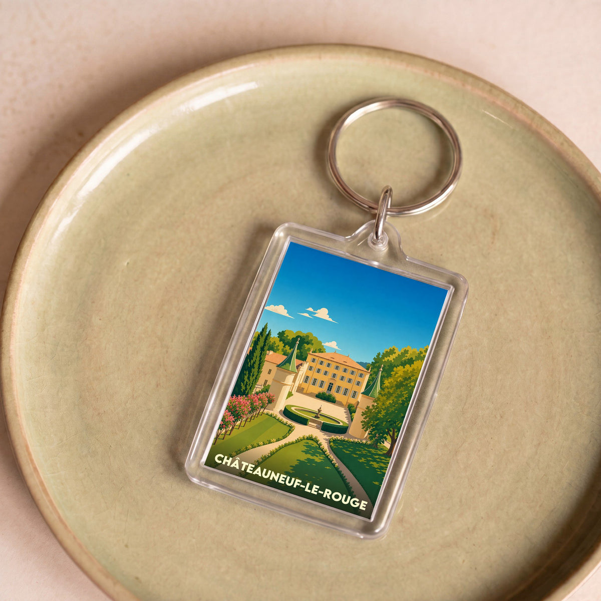 Porte-clés souvenir de la ville de Châteauneuf-le-Rouge avec une illustration stylisée de son château.