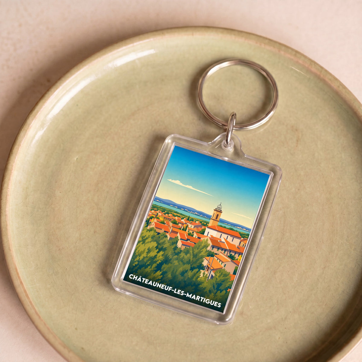 Porte-clés souvenir de la ville de Châteauneuf-les-Martigues avec une illustration stylisée.