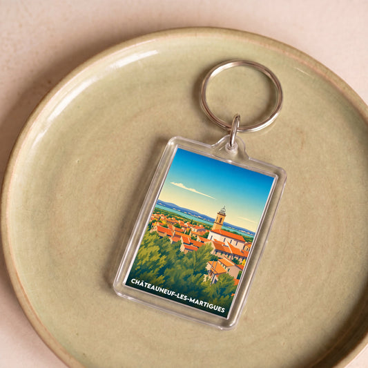 Porte-clés souvenir de la ville de Châteauneuf-les-Martigues avec une illustration stylisée.