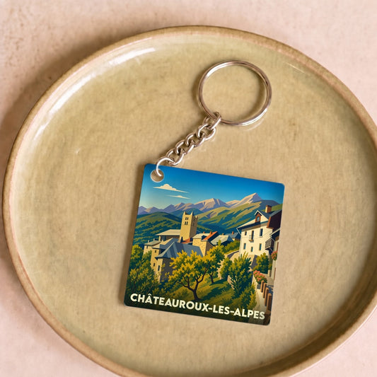 Porte-clés souvenir de la ville de Châteauroux-les-Alpes avec une illustration stylisée d'un paysage de montagne.