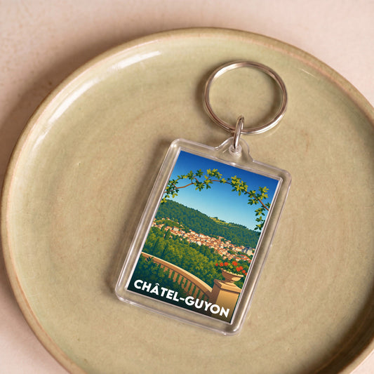Porte-clés souvenir de la ville de Châtel-Guyon avec une illustration stylisée.