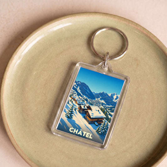 Porte-clés souvenir de la ville de Châtel avec une illustration hivernale stylisée.