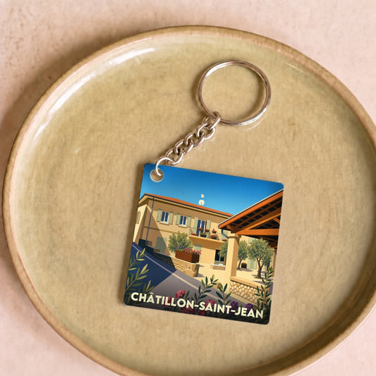 Porte-clés souvenir de la ville de Châtillon-Saint-Jean avec une illustration stylisée d'une maison ensoleillée.