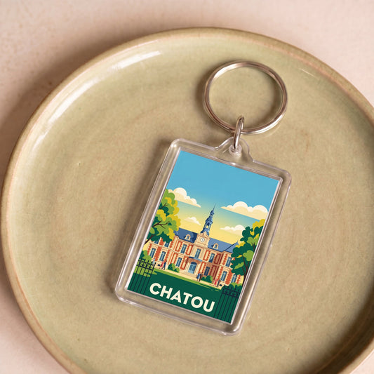 Porte-clés souvenir de la ville de Chatou avec une illustration stylisée d'un bâtiment historique.