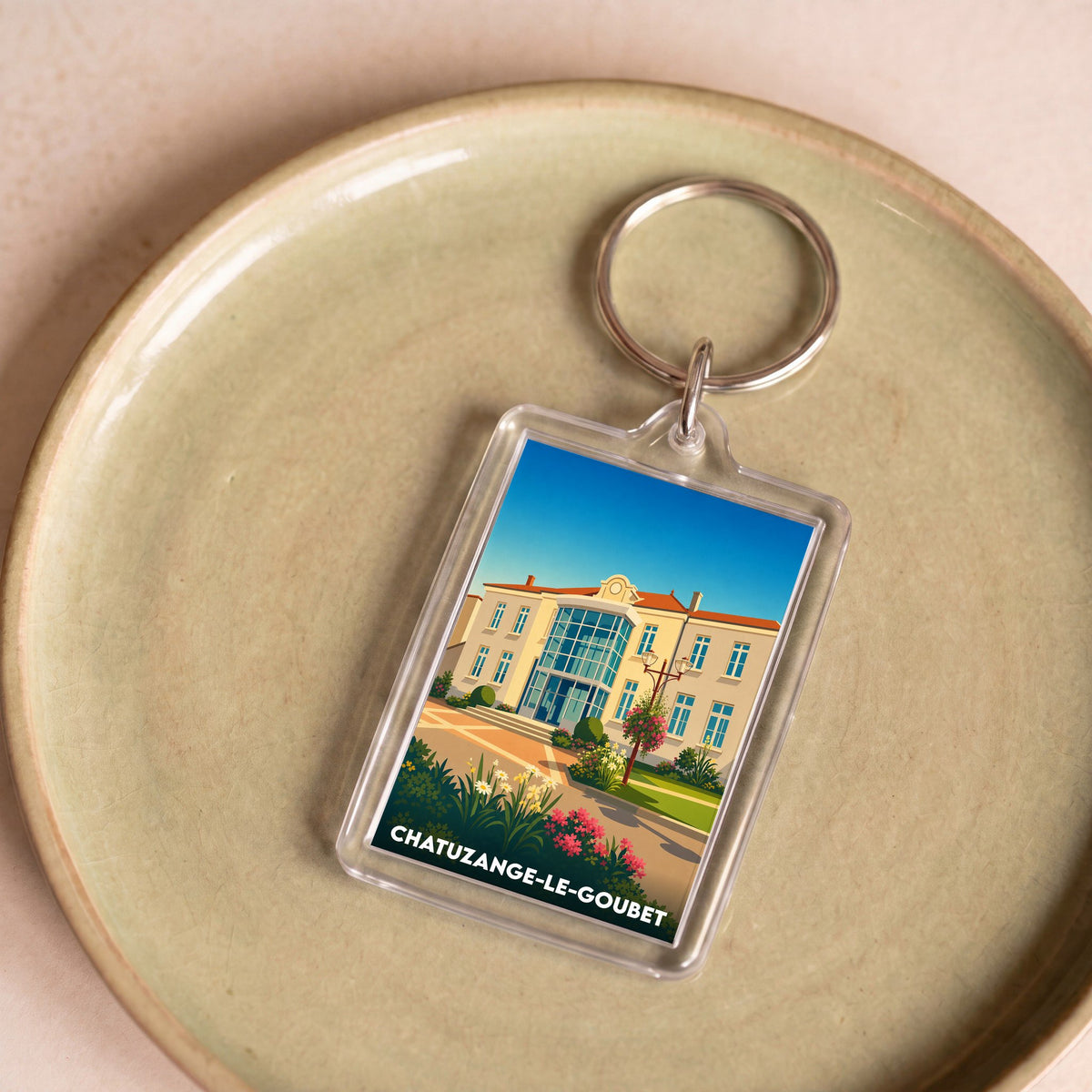Porte-clés souvenir de la ville de Chatuzange-le-Goubet avec une illustration stylisée.
