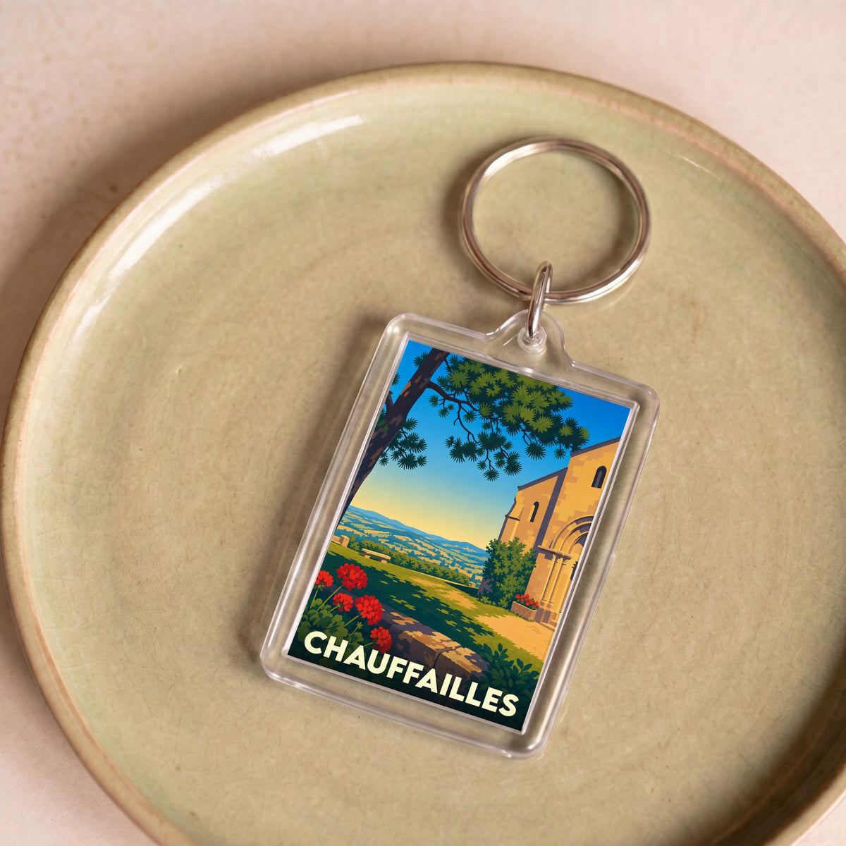 Porte-clés souvenir de la ville de Chauffailles avec une illustration stylisée.