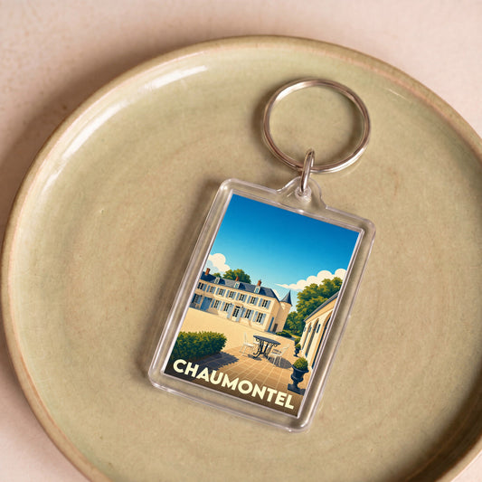 Porte-clés souvenir de la ville de Chaumontel avec une illustration stylisée d'une demeure historique.