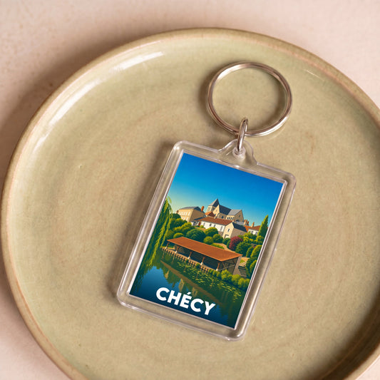 Porte-clés souvenir de la ville de Chécy avec une illustration colorée et stylisée.