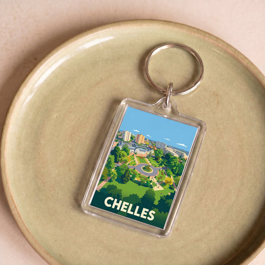 Porte-clés souvenir de la ville de Chelles avec une illustration stylisée.