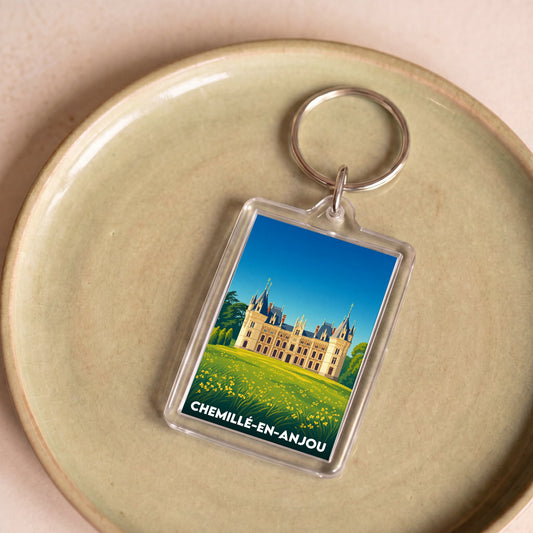 Porte-clés souvenir de la ville de Chemillé-en-Anjou avec une illustration stylisée d'un château.