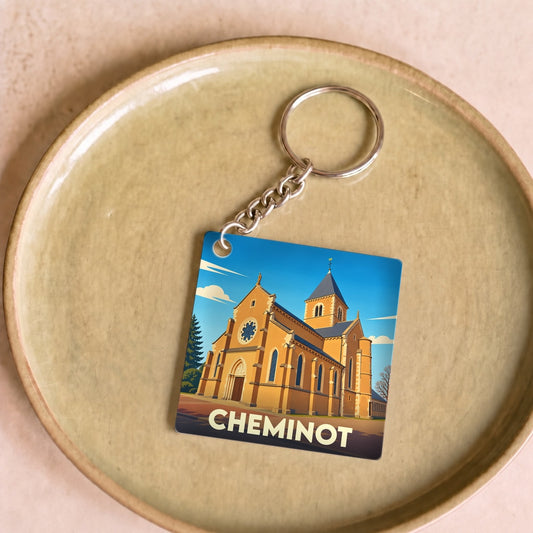 Porte-clés souvenir de la ville de Cheminot avec une illustration stylisée de son église.
