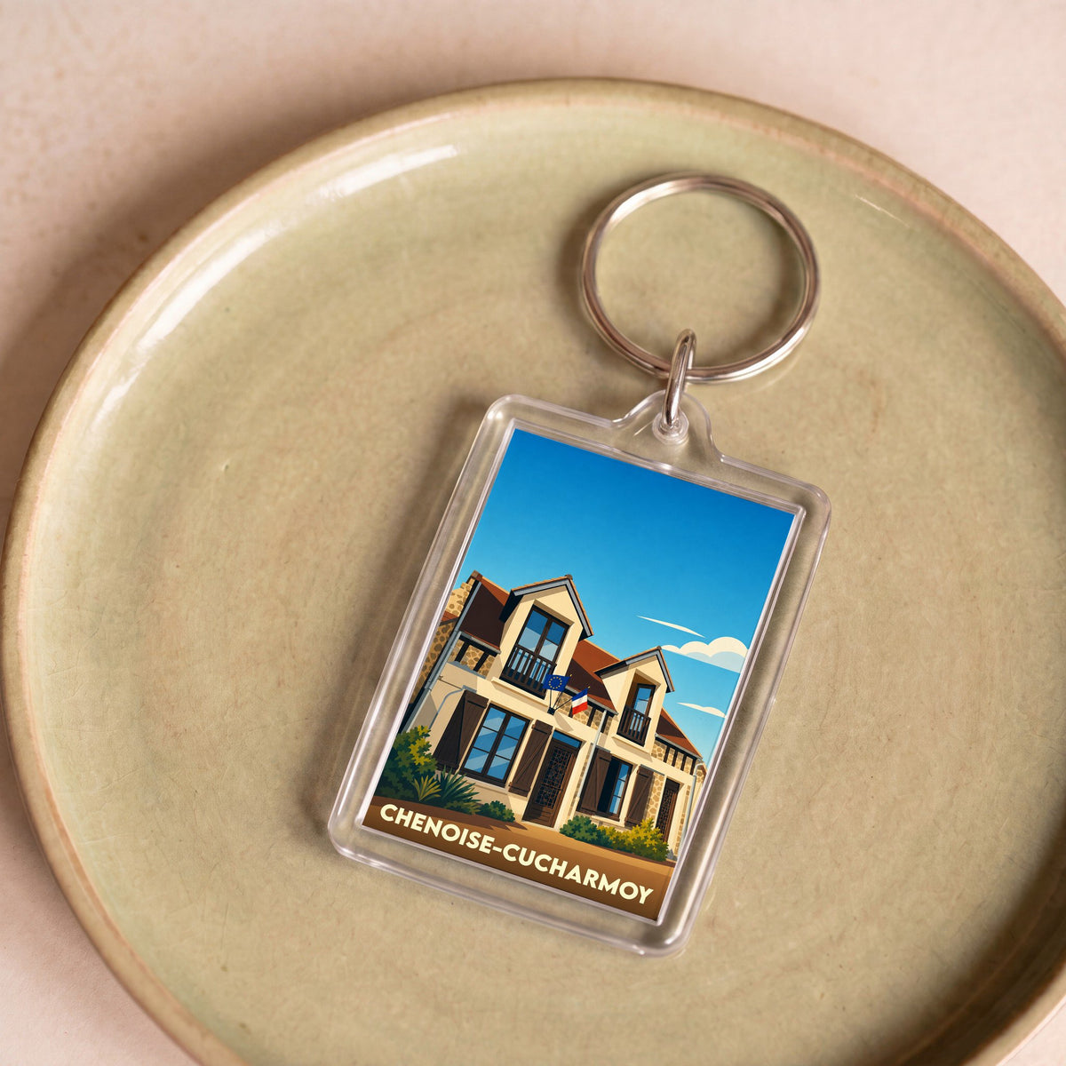 Porte-clés souvenir de la commune de Chenoise-Cucharmoy avec une illustration stylisée de la mairie.