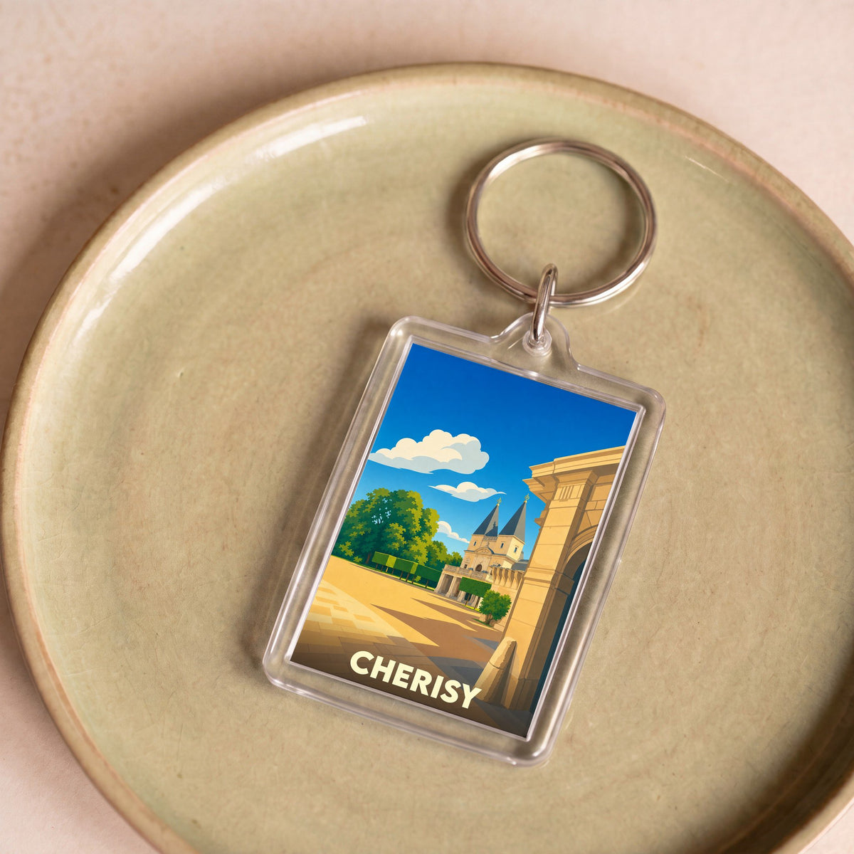 Porte-clés souvenir de la ville de Cherisy avec une illustration stylisée.