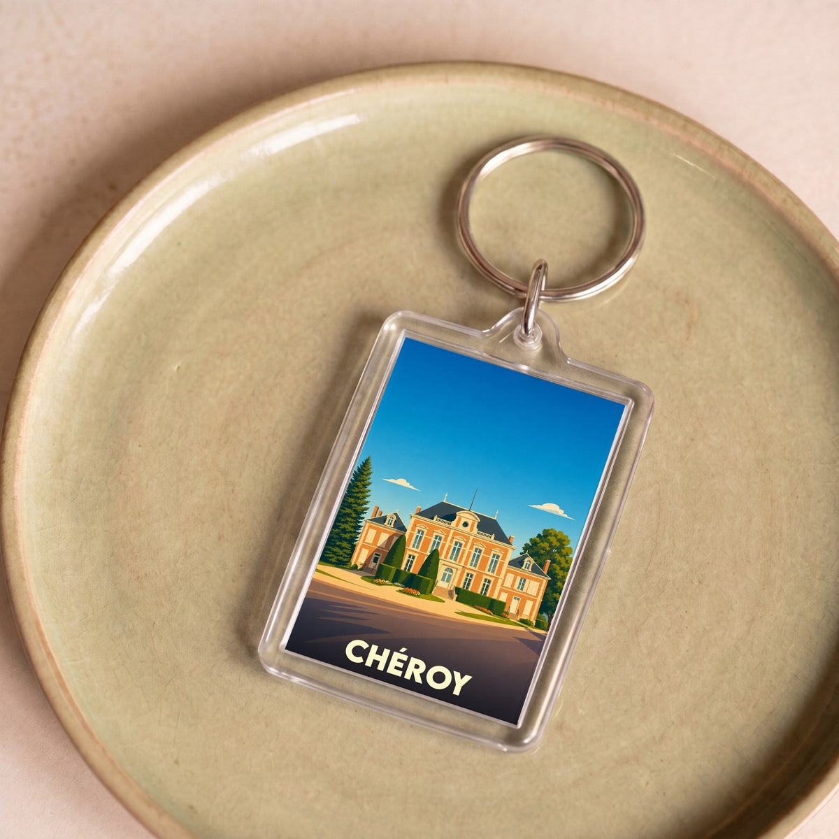 Porte-clés souvenir de la ville de Chéroy avec une illustration stylisée de son hôtel de ville.