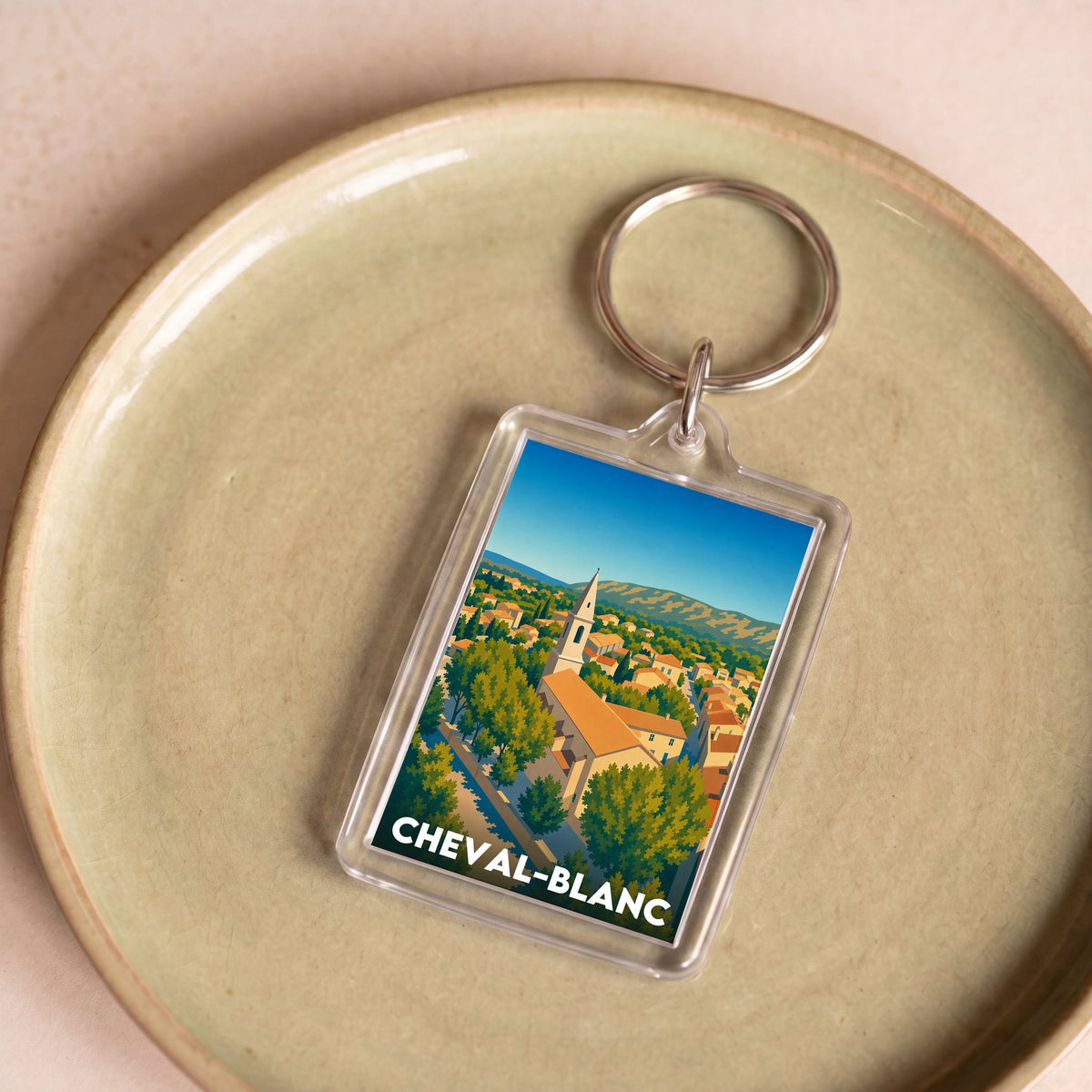 Porte-clés souvenir de la ville de Cheval-Blanc avec une illustration stylisée.