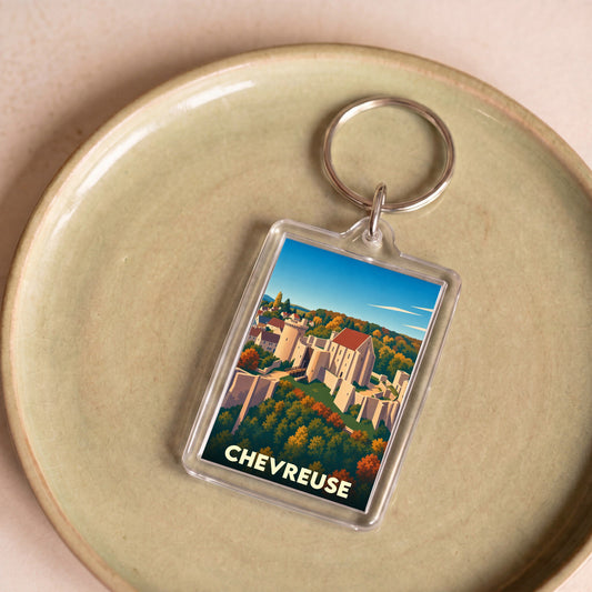 Porte-clés souvenir de la ville de Chevreuse avec une illustration stylisée du château et de la vallée.