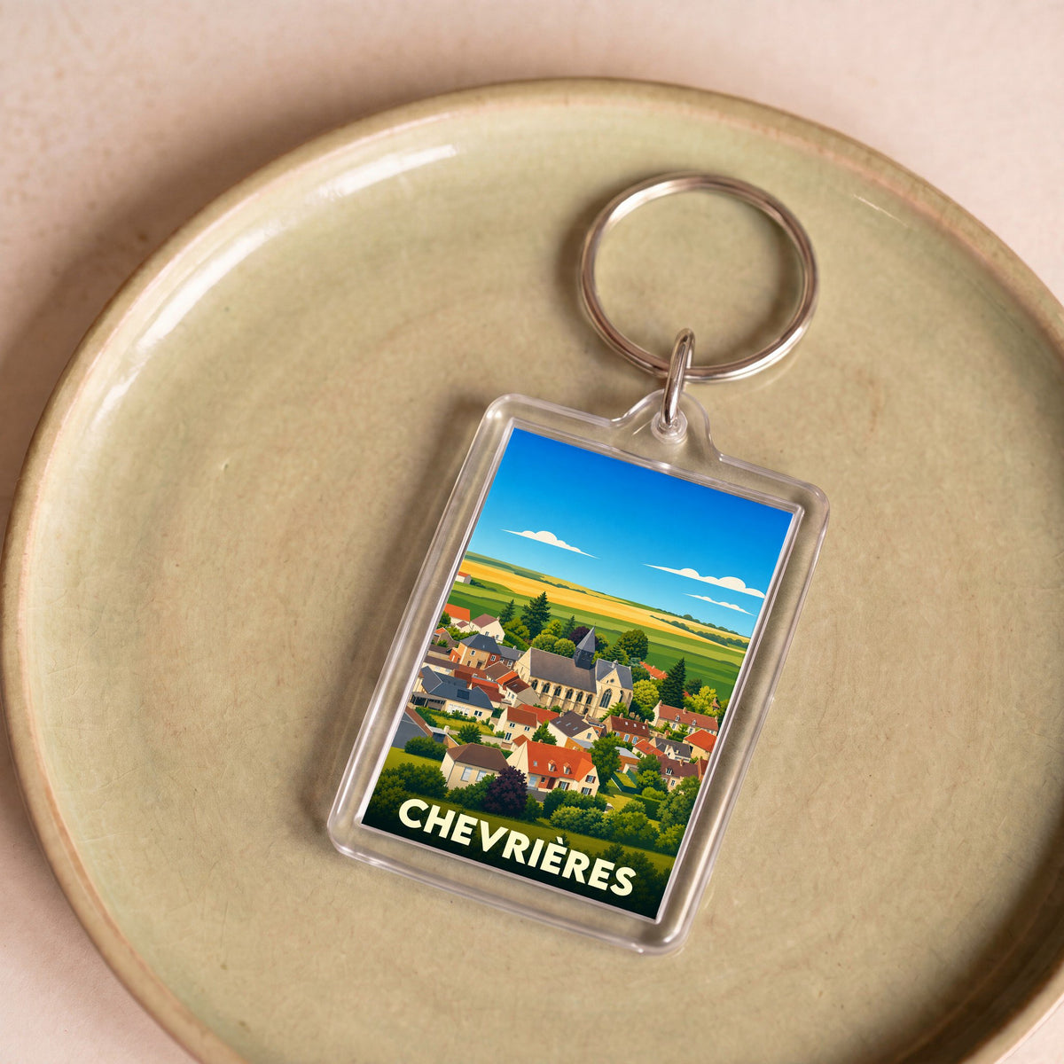 Porte-clés souvenir de la ville de Chevrières avec une illustration stylisée.