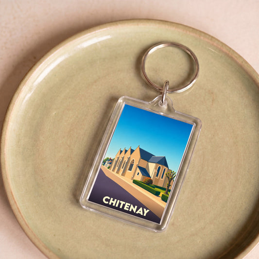 Porte-clés souvenir de la ville de Chitenay avec une illustration stylisée de son église.