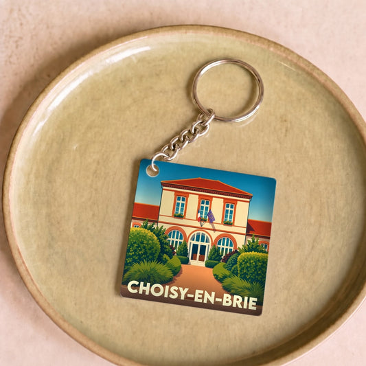 Porte-clés souvenir de la ville de Choisy-en-Brie avec une illustration stylisée de sa mairie.