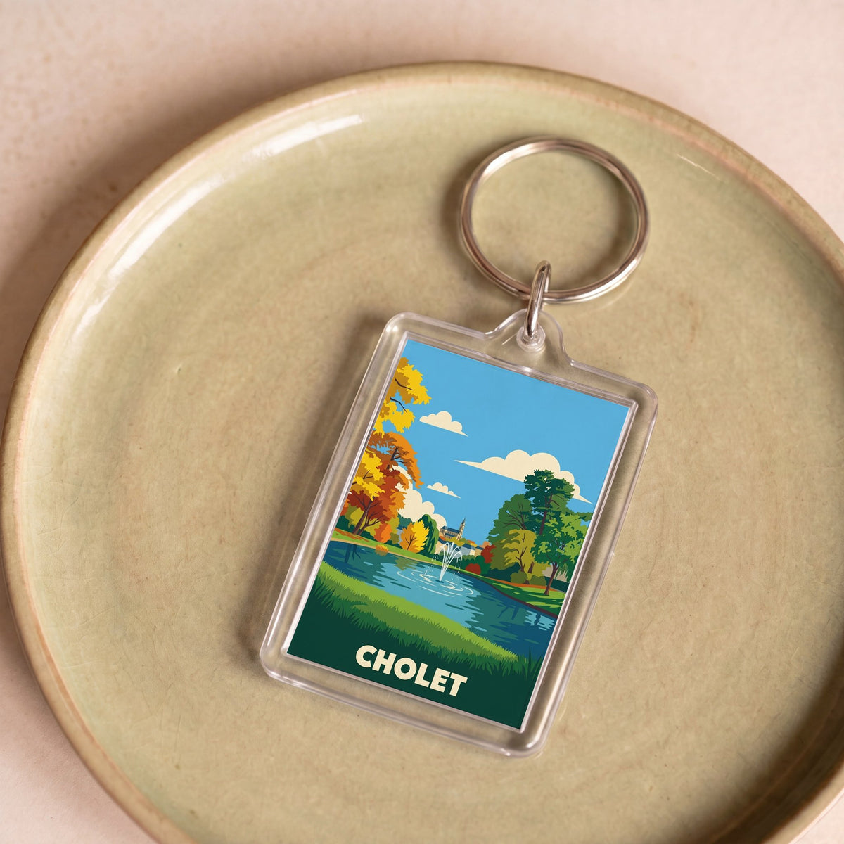 Porte-clés souvenir de la ville de Cholet avec une illustration stylisée.