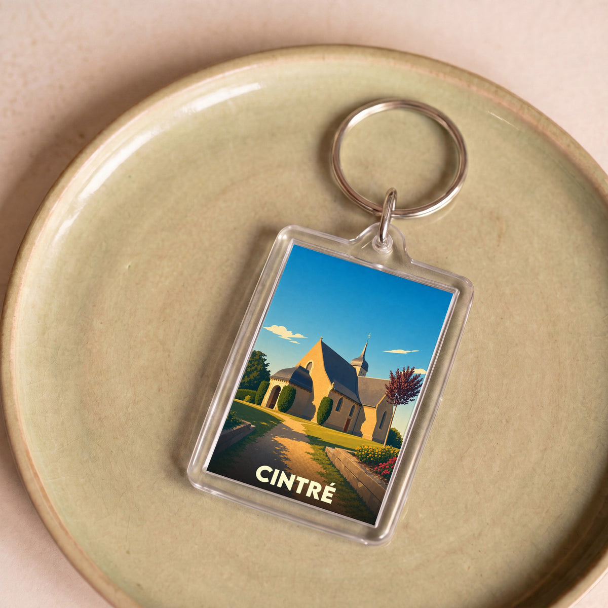 Porte-clés souvenir de la ville de Cintré avec une illustration stylisée de son église.