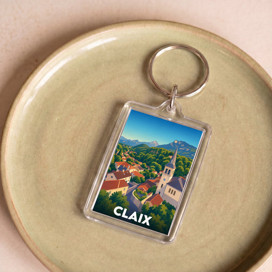 Porte-clés souvenir de la ville de Claix avec une illustration stylisée d'un paysage montagneux.