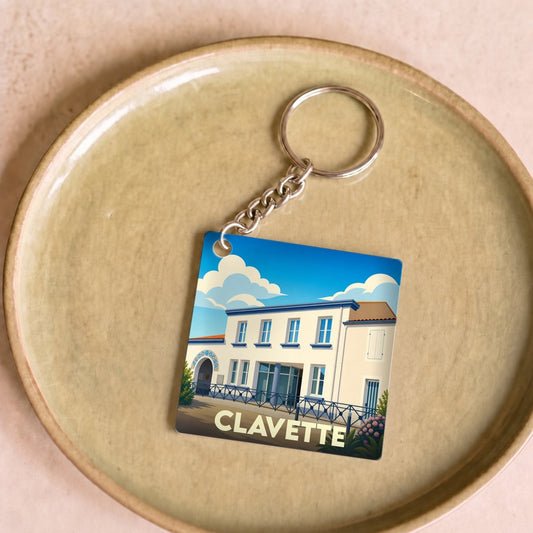 Porte-clés souvenir de la ville de Clavette avec une illustration stylisée de son architecture.