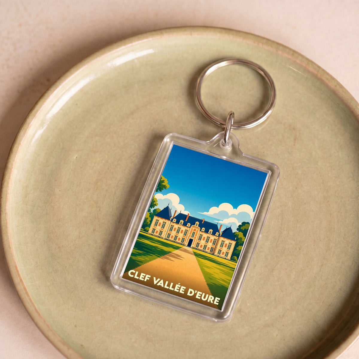 Porte-clés souvenir de la commune de Clef Vallée d'Eure avec une illustration stylisée de son château.