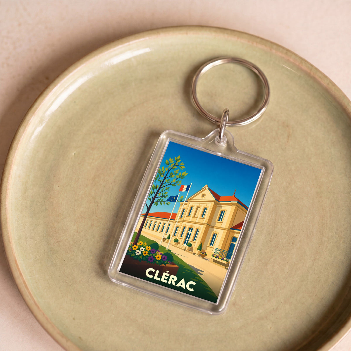 Porte-clés souvenir de la ville de Clérac avec une illustration stylisée de la mairie.