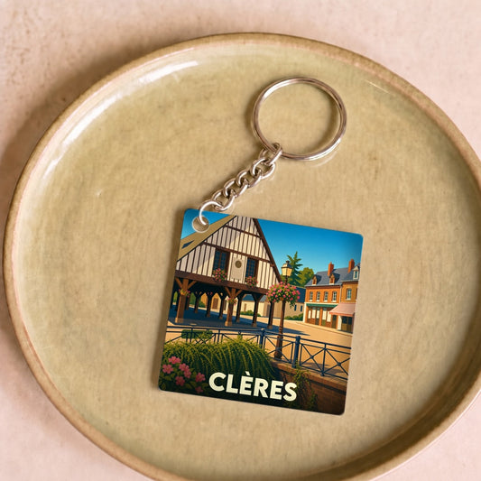 Porte-clés souvenir de la ville de Clères avec une illustration stylisée de ses halles historiques.