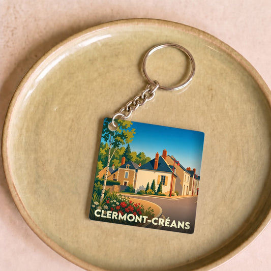 Porte-clés souvenir de Clermont-Créans avec une illustration colorée et stylisée de la ville.