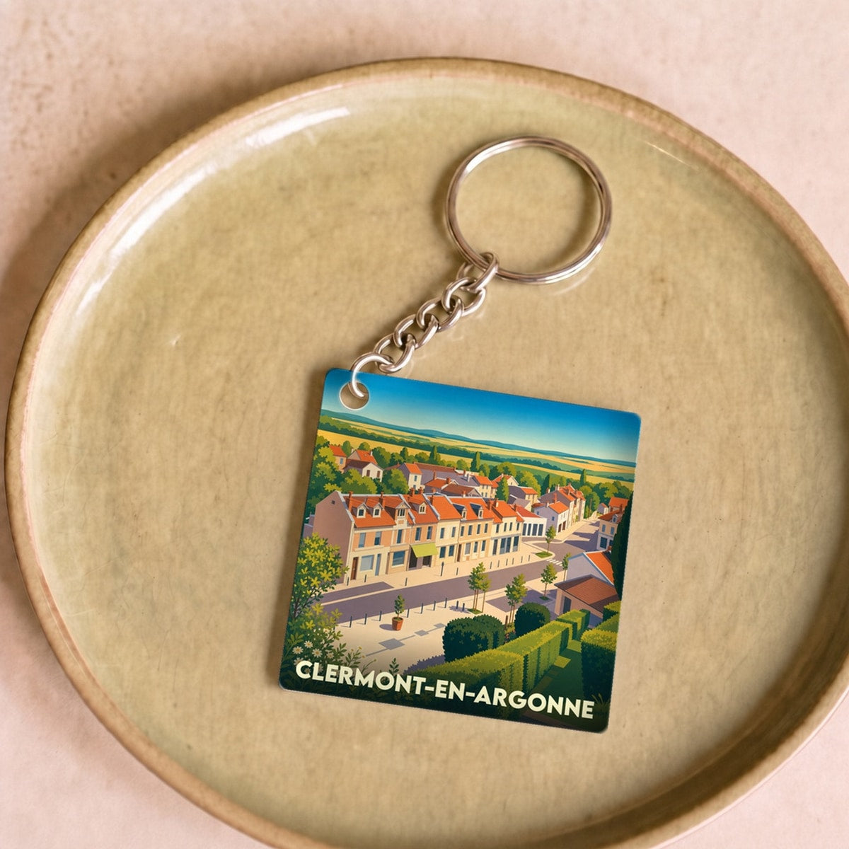 Porte-clés souvenir de la ville de Clermont-en-Argonne avec une illustration stylisée.