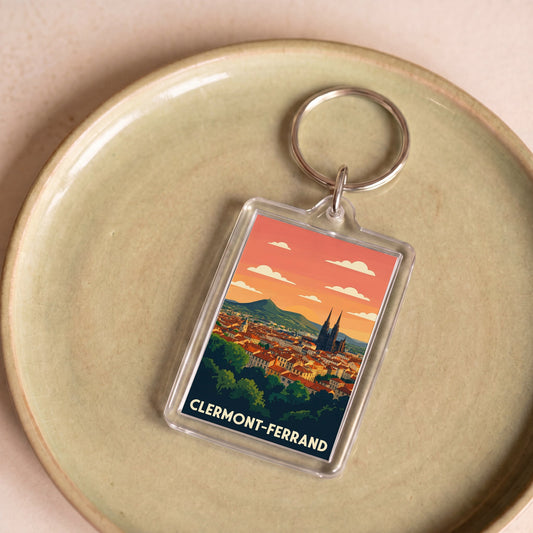 Porte-clés souvenir de la ville de Clermont-Ferrand avec une illustration stylisée.
