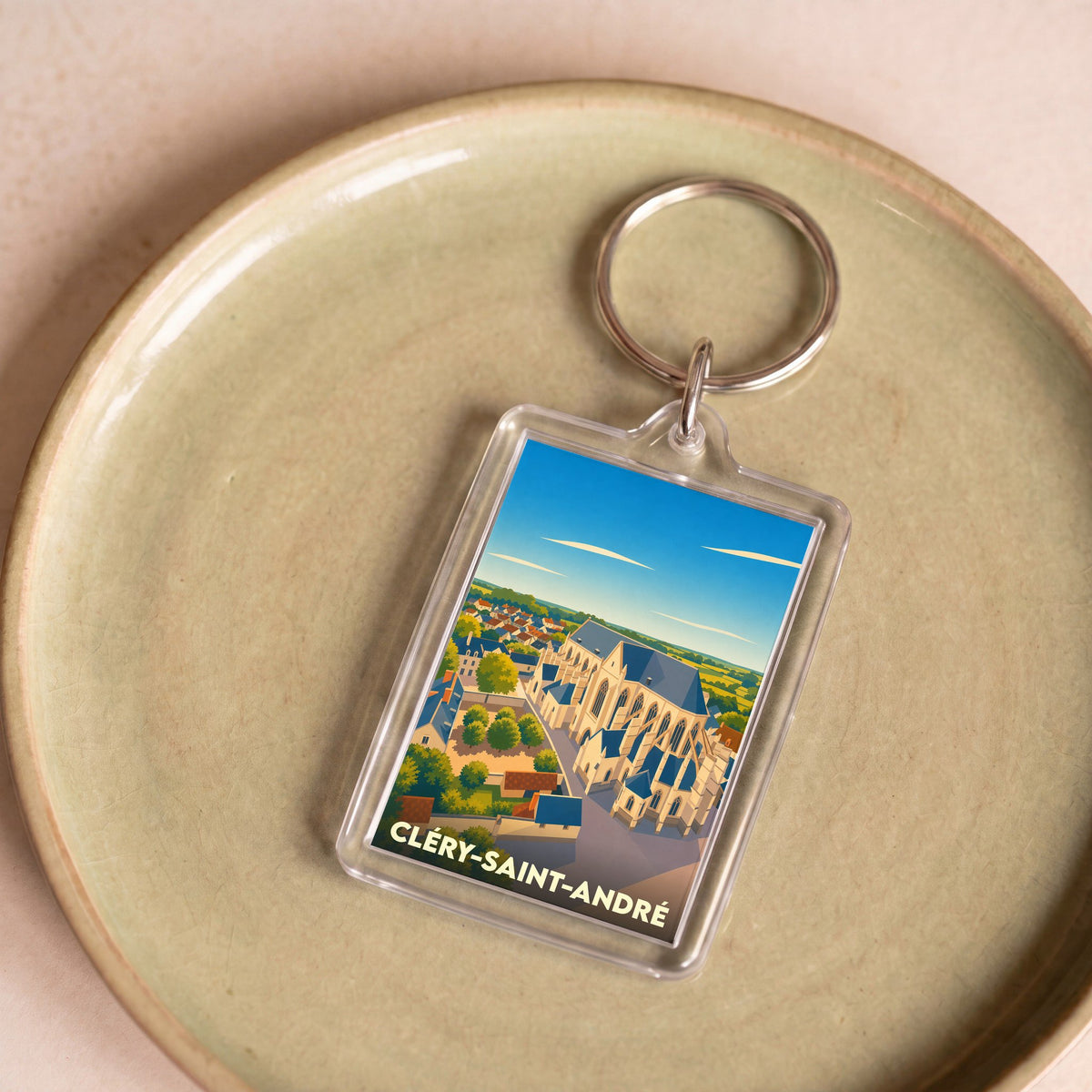 Porte-clés souvenir de la ville de Cléry-Saint-André avec une illustration stylisée de sa basilique.