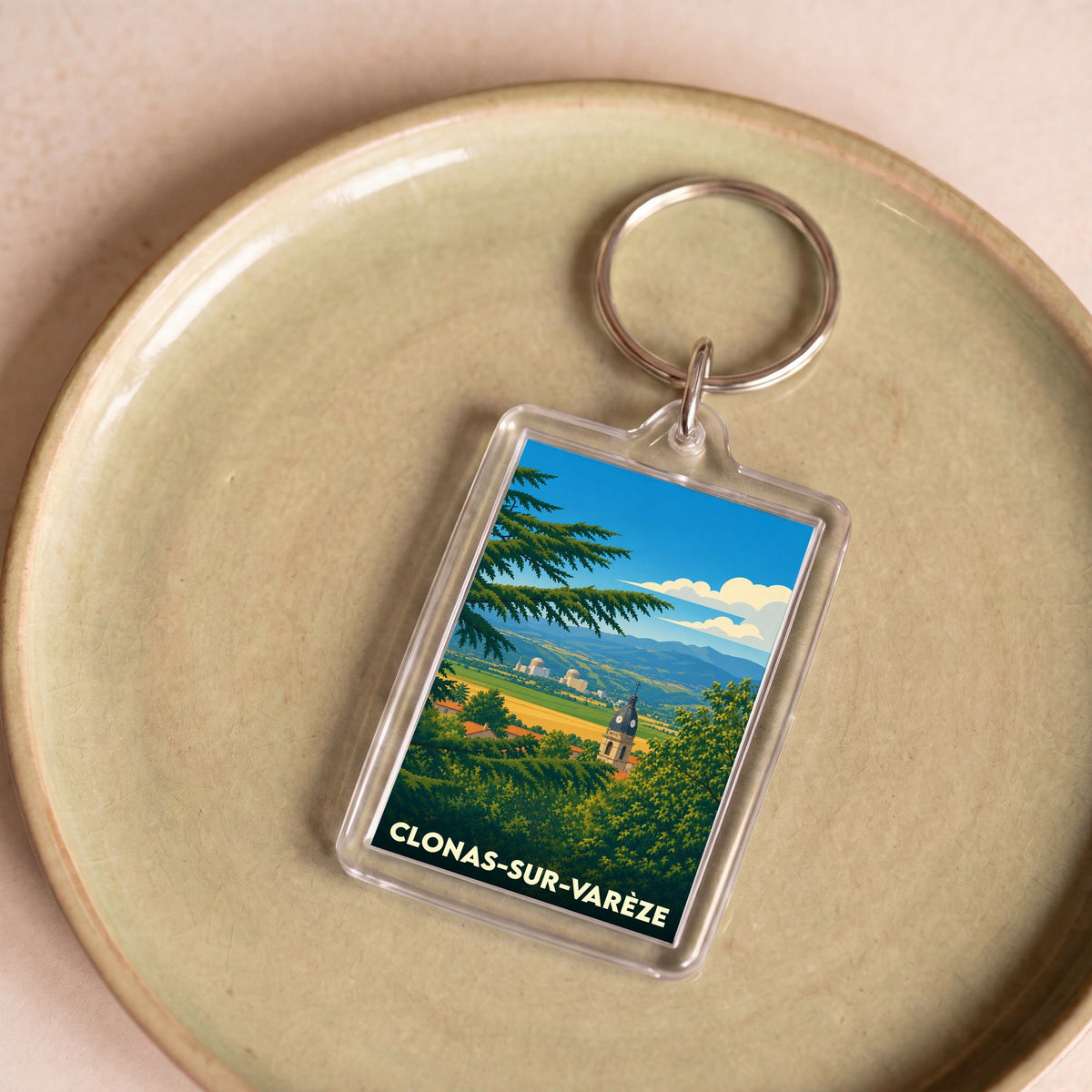 Porte-clés souvenir de Clonas-sur-Varèze illustré d'un paysage panoramique stylisé de la ville.