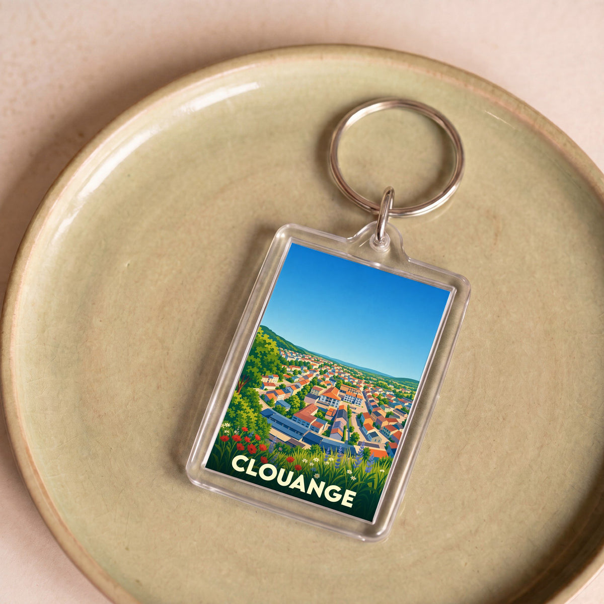 Porte-clés souvenir de la ville de Clouange avec une illustration stylisée.