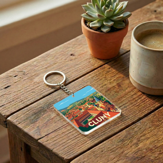 Porte-clés souvenir de la ville de Cluny avec une illustration panoramique stylisée.